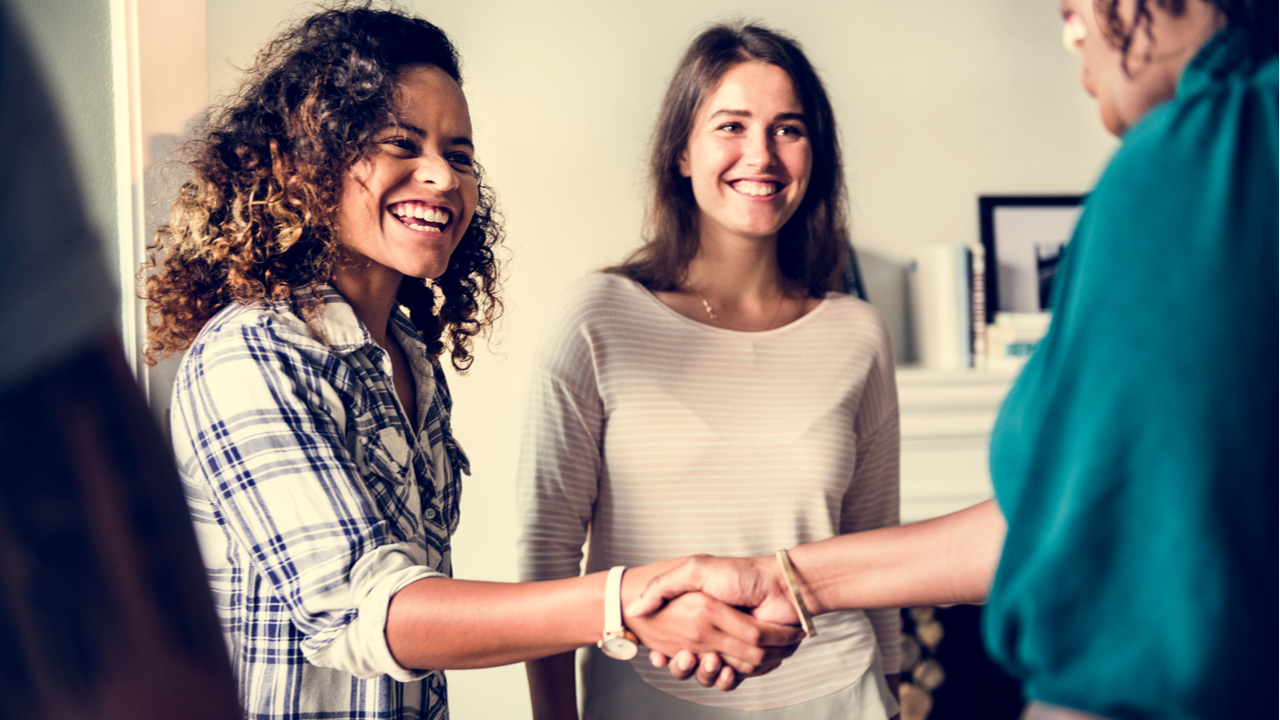 Two women shaking hands. 