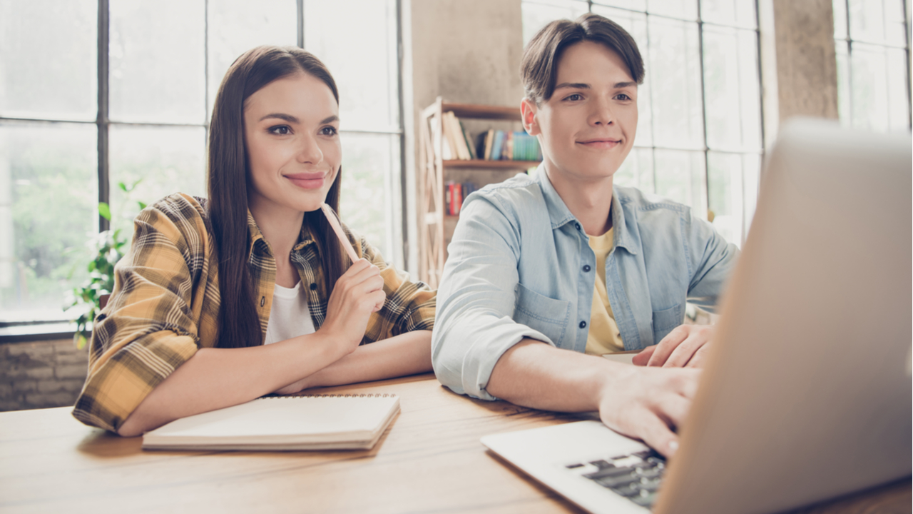 Guy and girl studying with laptop