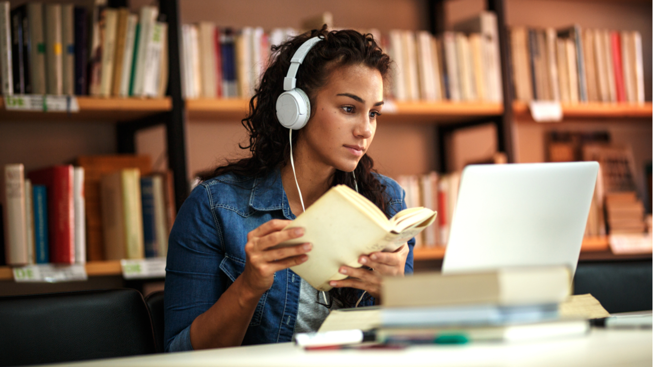 Student with book and laptop